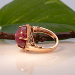 14K rose gold star ruby cabochon ring with diamond halo
