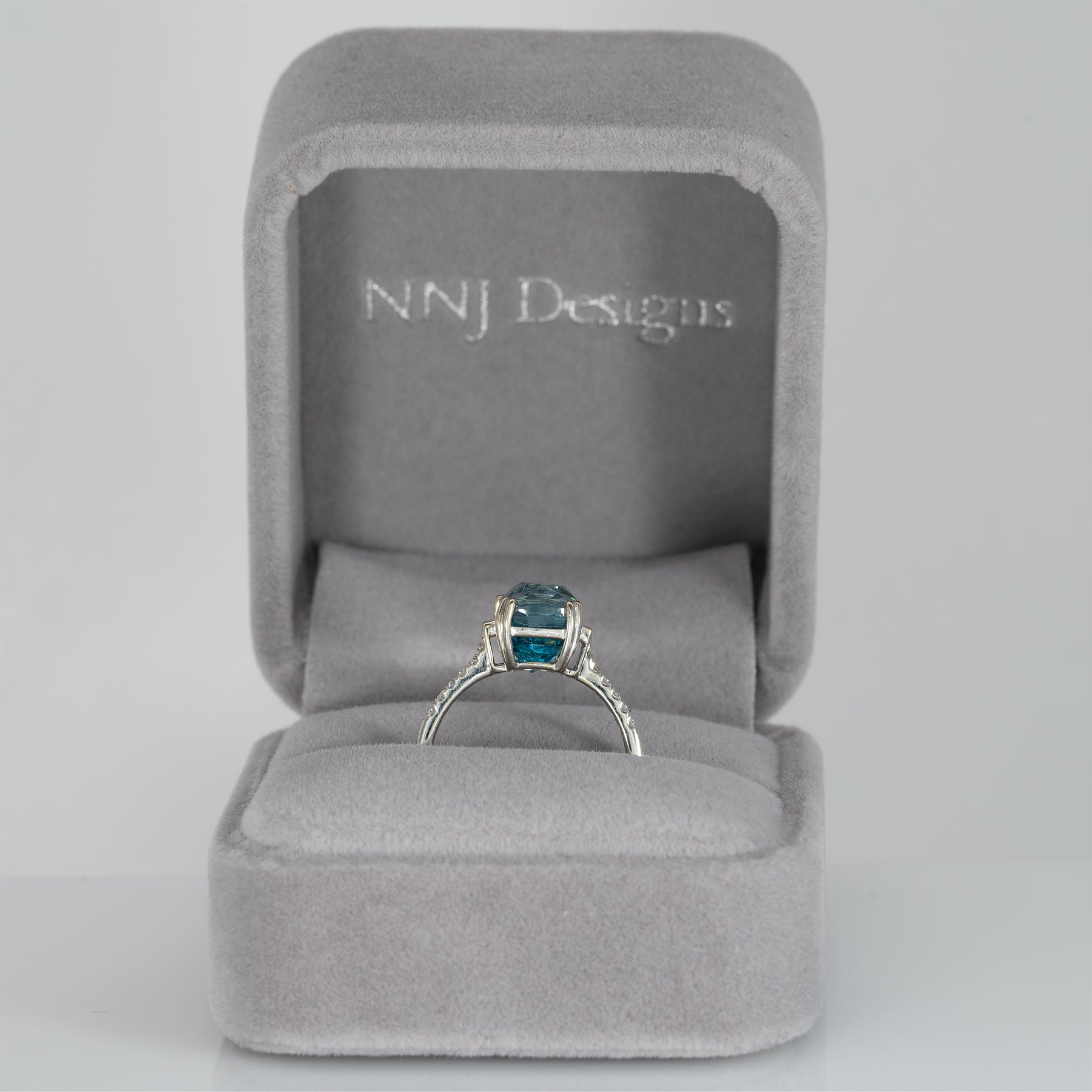 14K white gold Cambodian blue zircon cushion ring with diamond accents