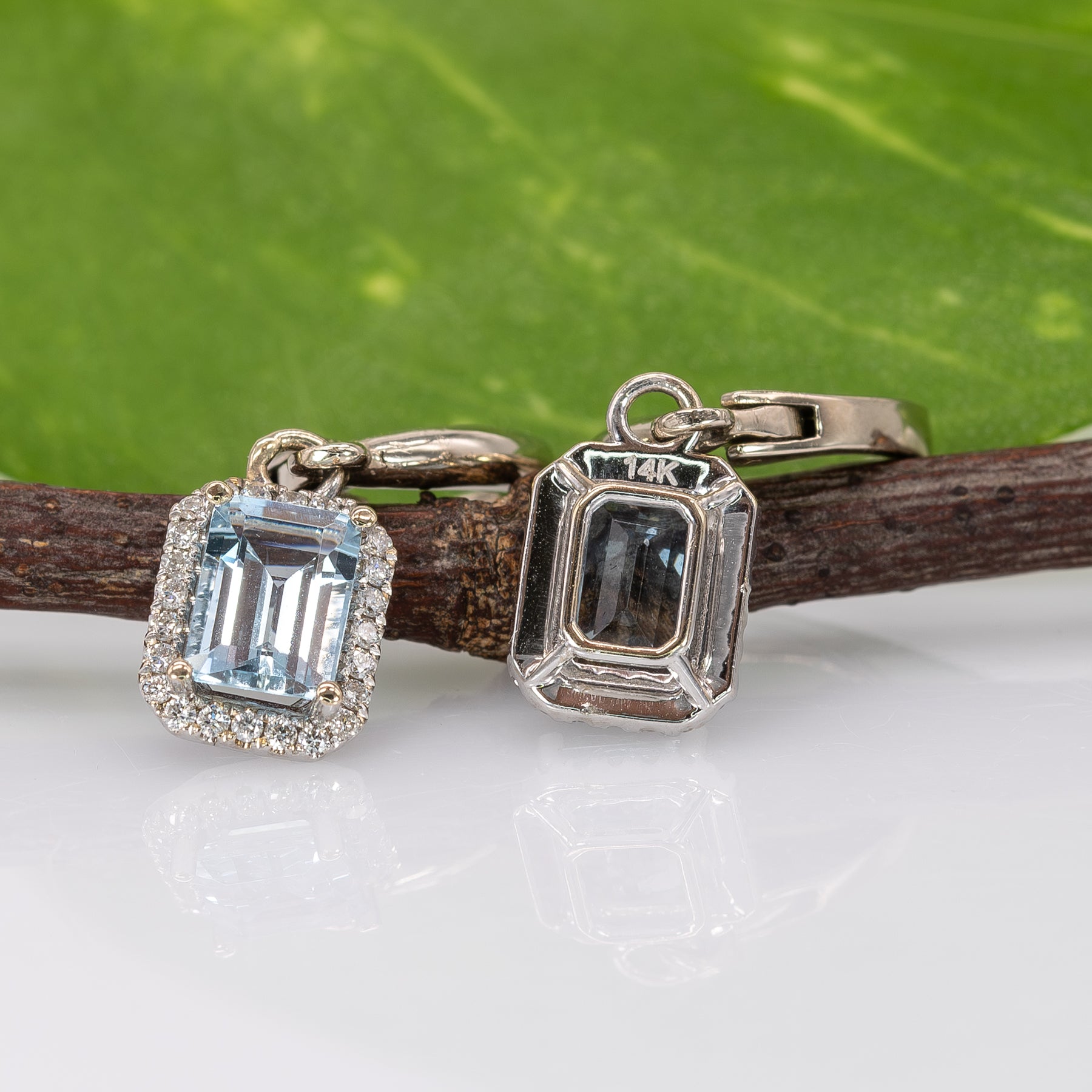 14K white gold aquamarine emerald-cut stud earrings with diamond halo