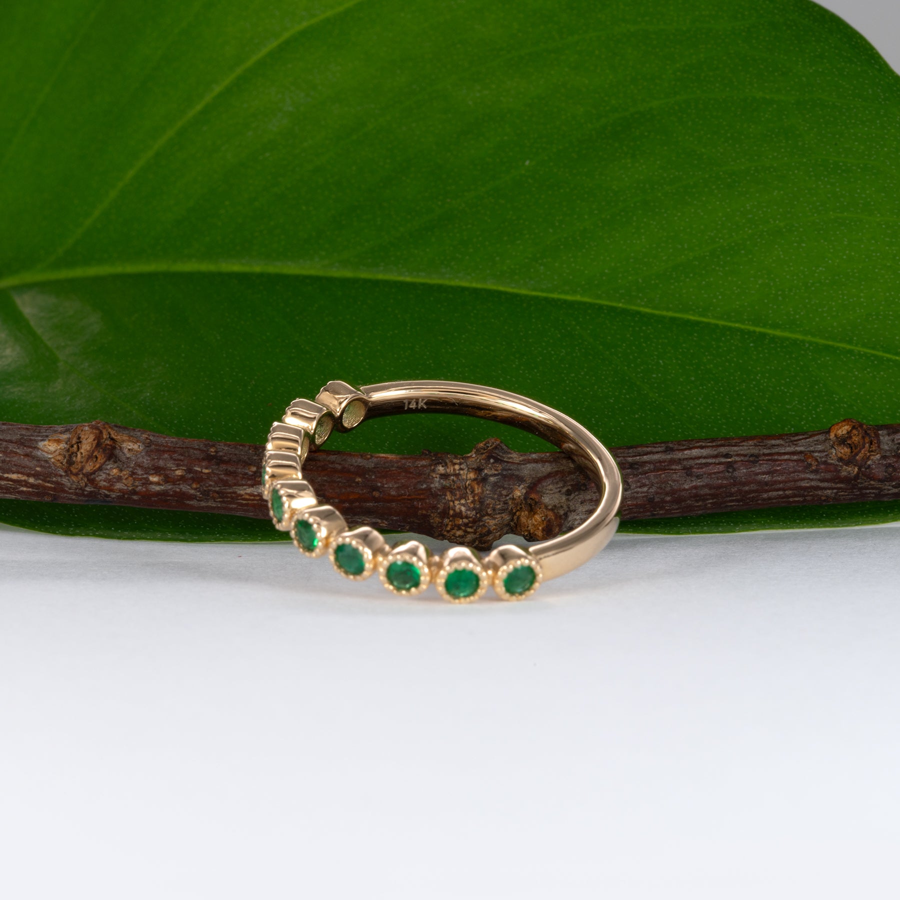 14K yellow gold band with round Zambian emerald accents