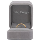 14K yellow gold band with round Zambian emerald accents