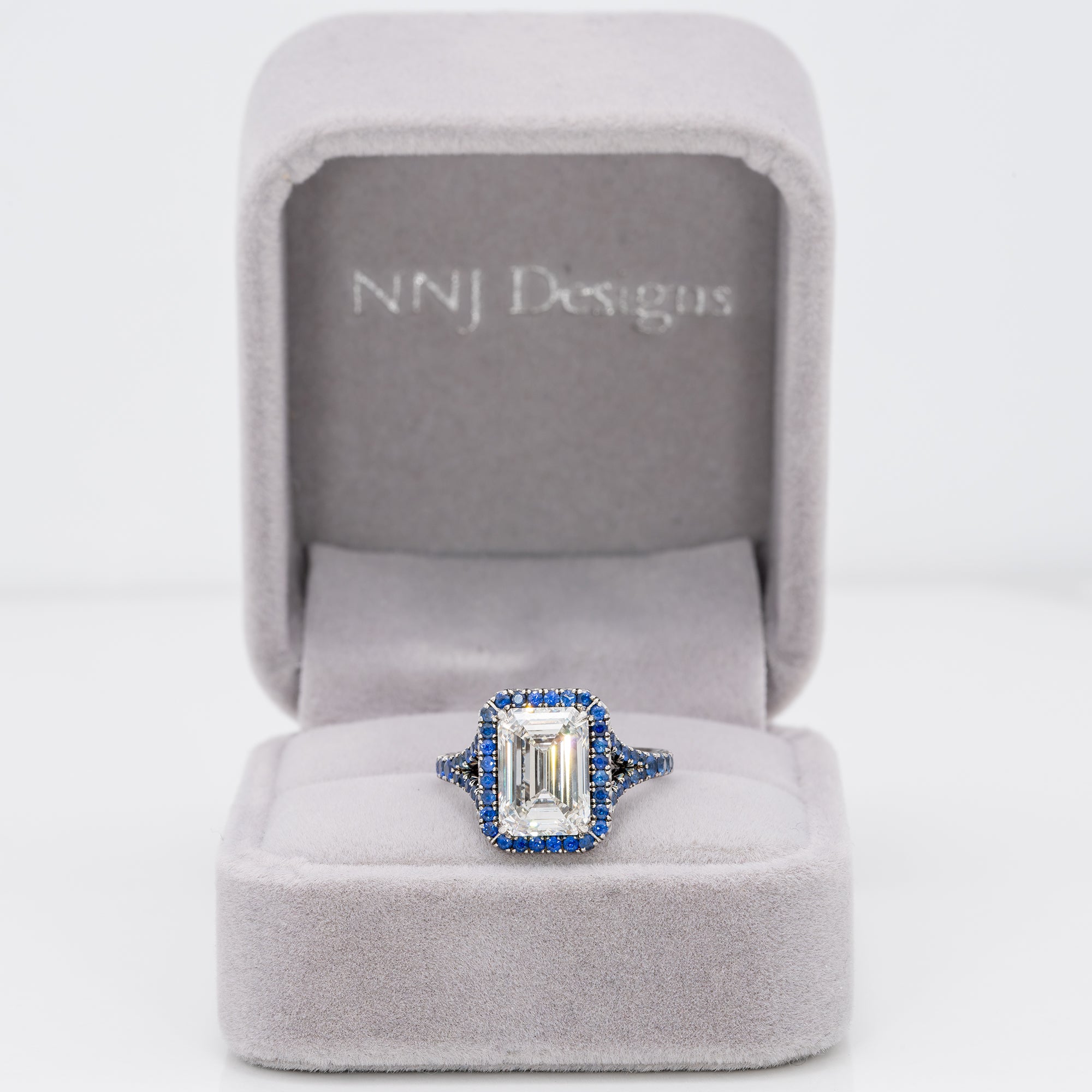 platinum lab grown diamond ring with blue sapphire accents