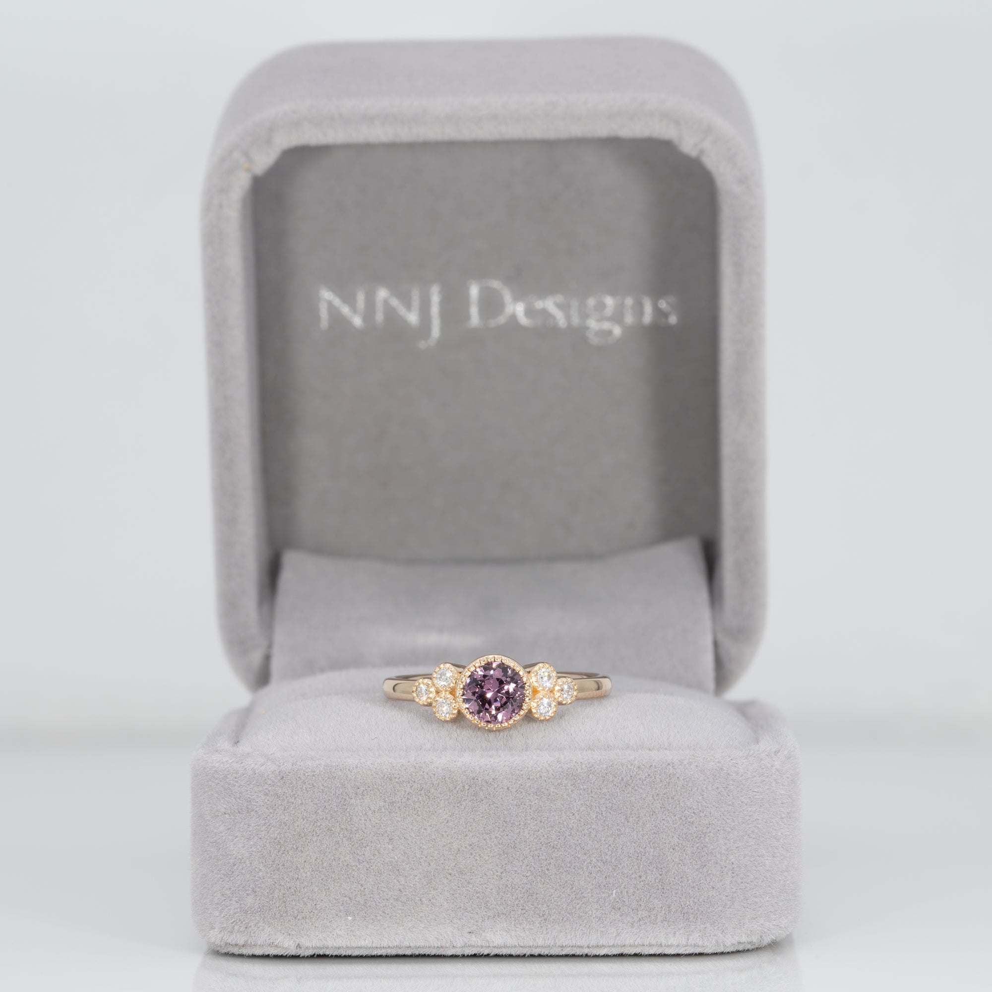 14K yellow gold bezel-set purple spinel ring with diamond accents
