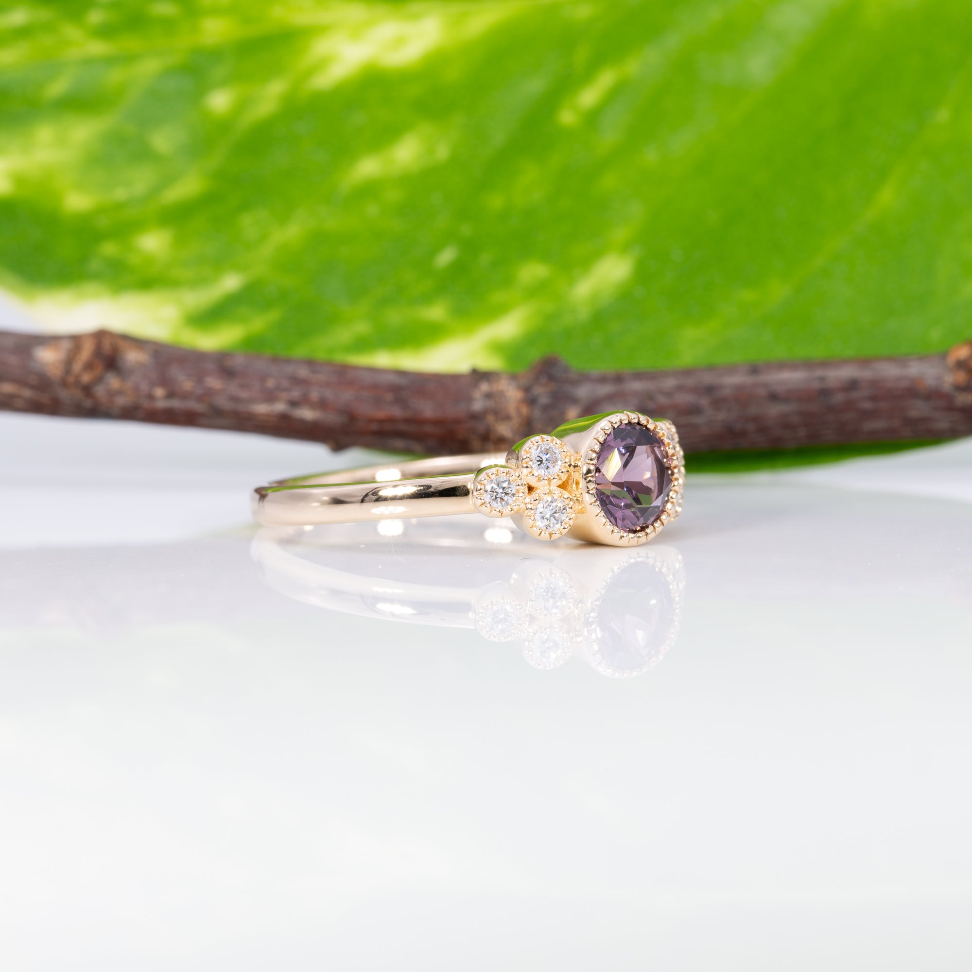 14K yellow gold bezel-set purple spinel ring with diamond accents