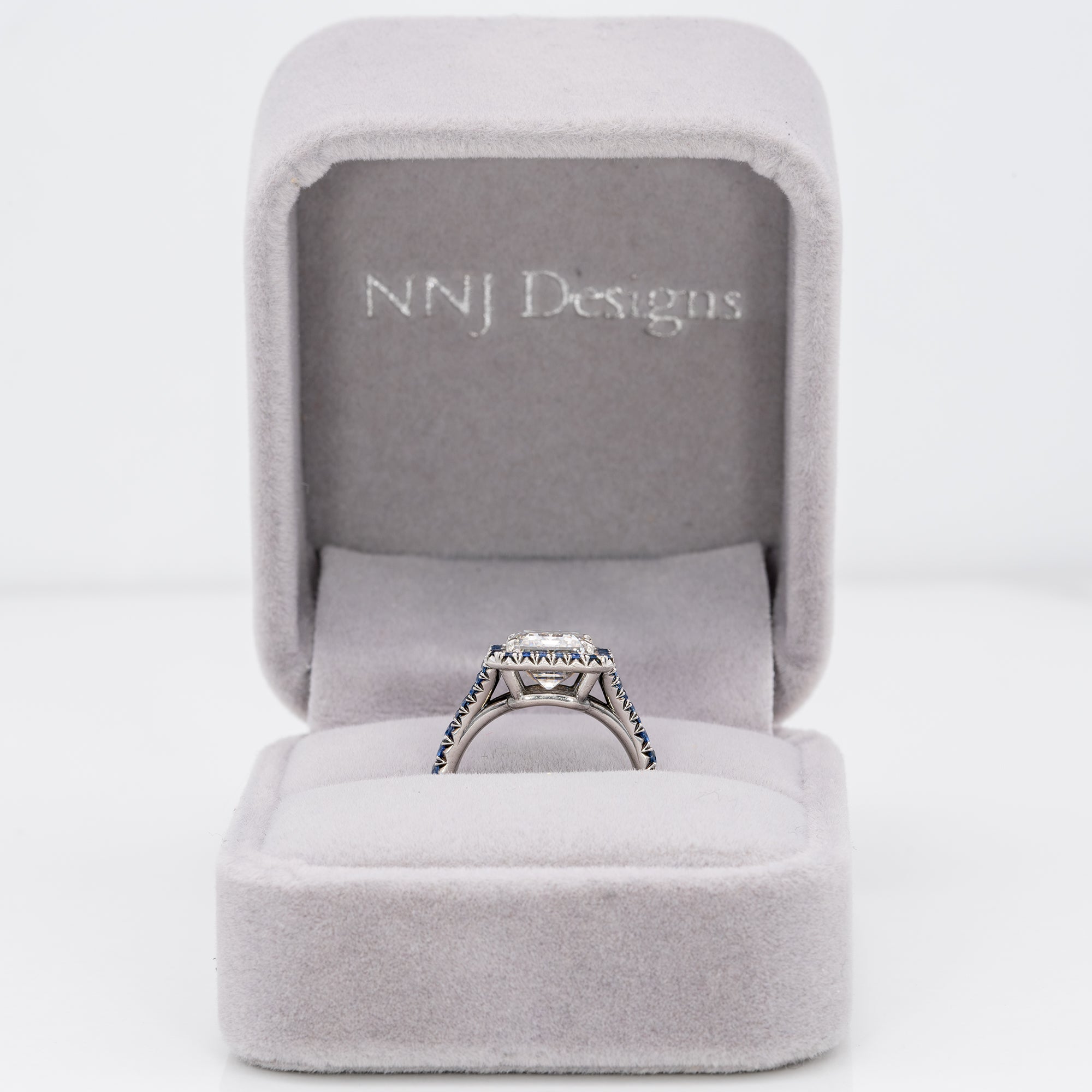 platinum lab grown diamond ring with blue sapphire accents