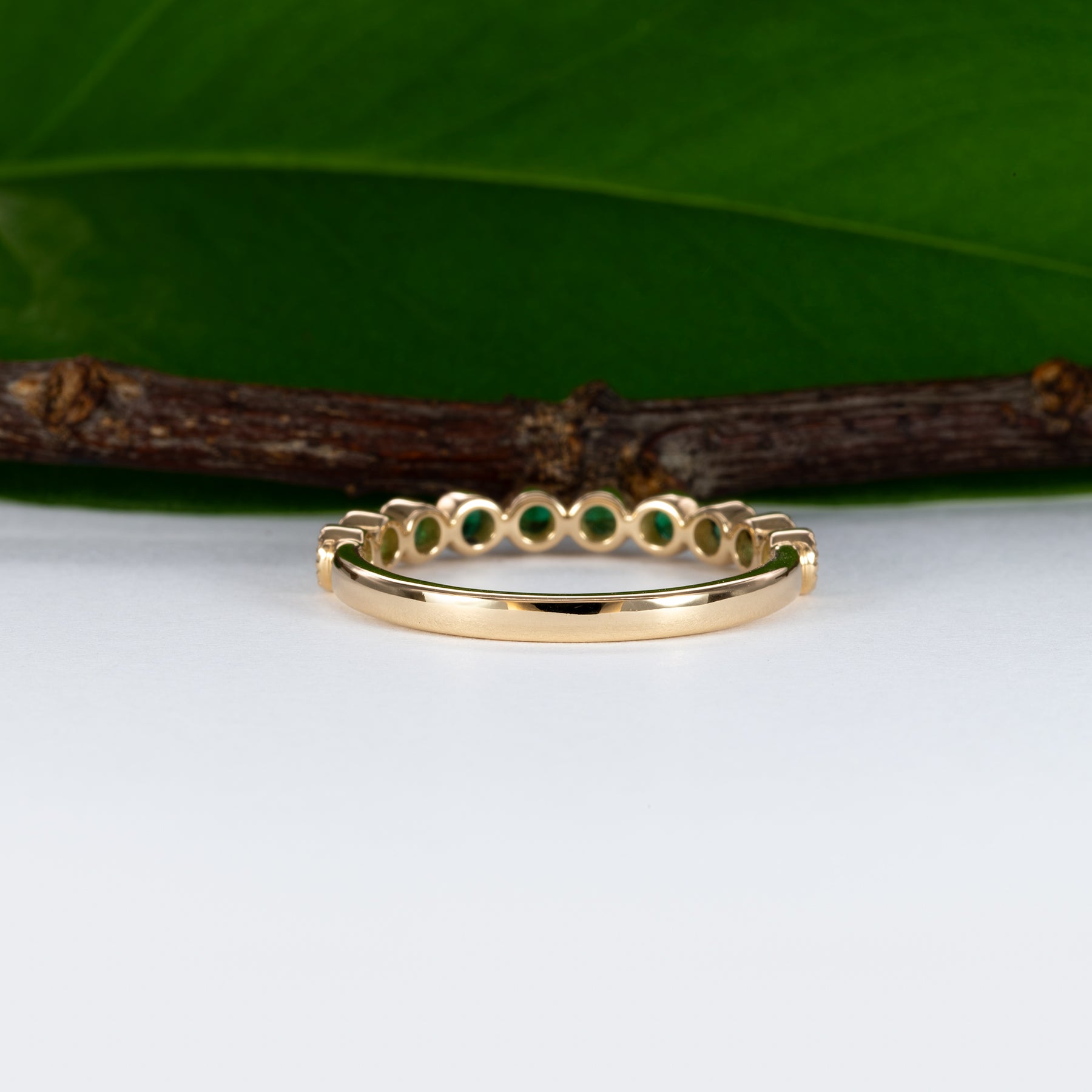 14K yellow gold band with round Zambian emerald accents