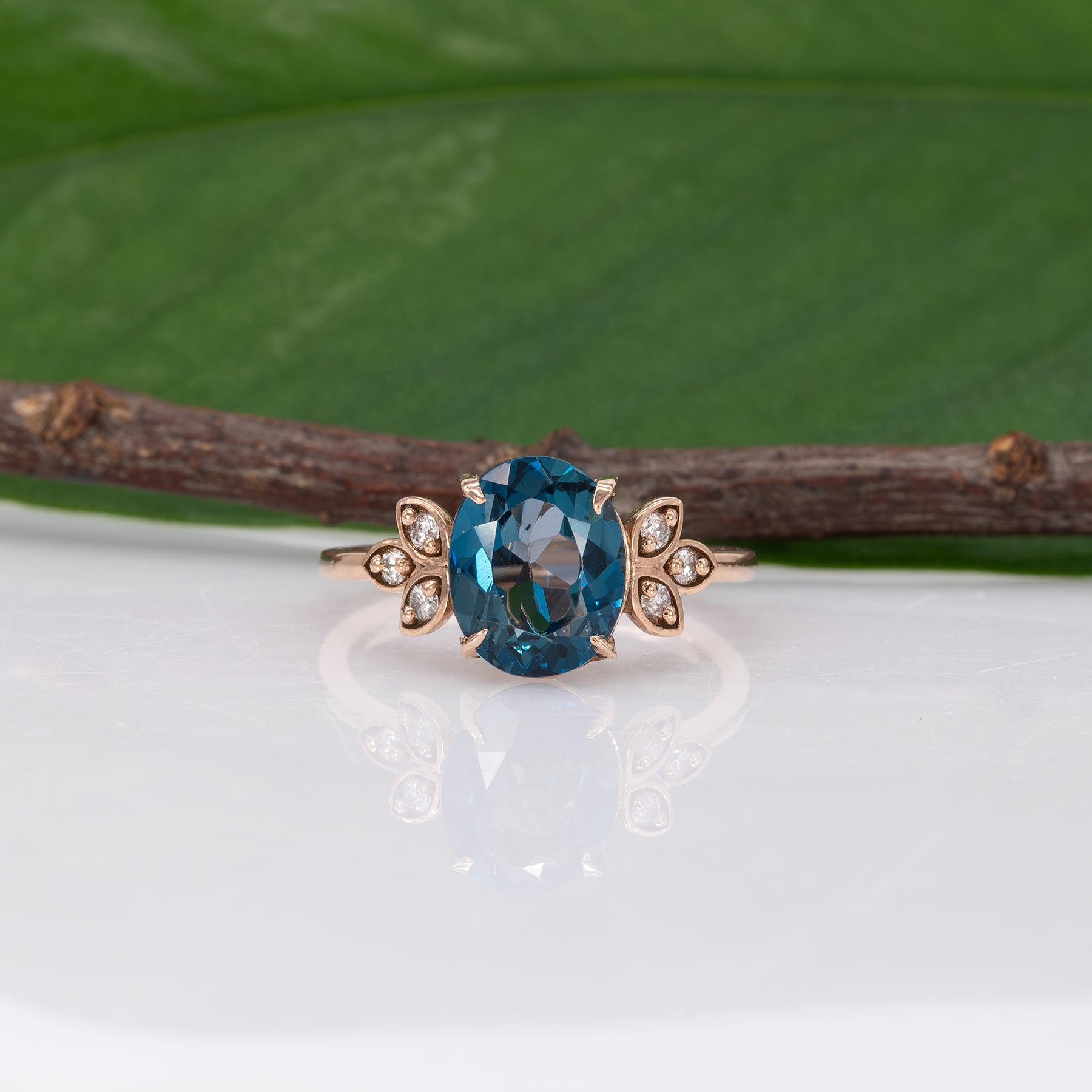 14K rose gold London blue topaz ring with diamond accents