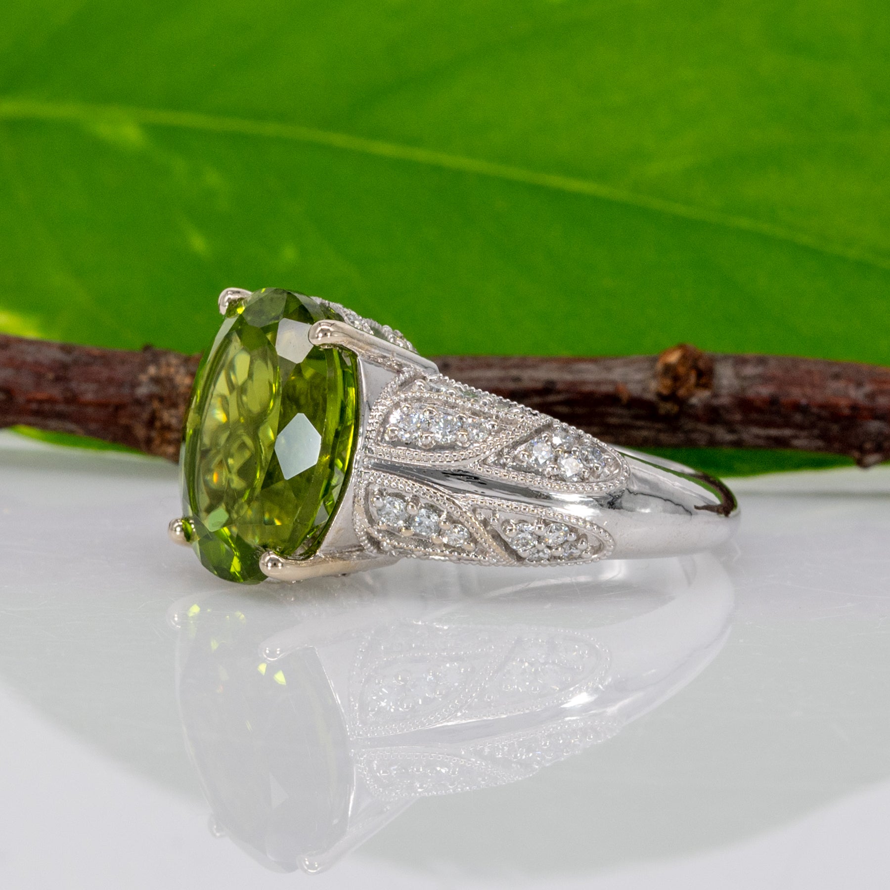 14K white gold peridot oval ring with diamond halo
