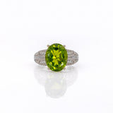 14K white gold peridot oval ring with diamond halo