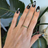 14K yellow gold band with round Zambian emerald accents