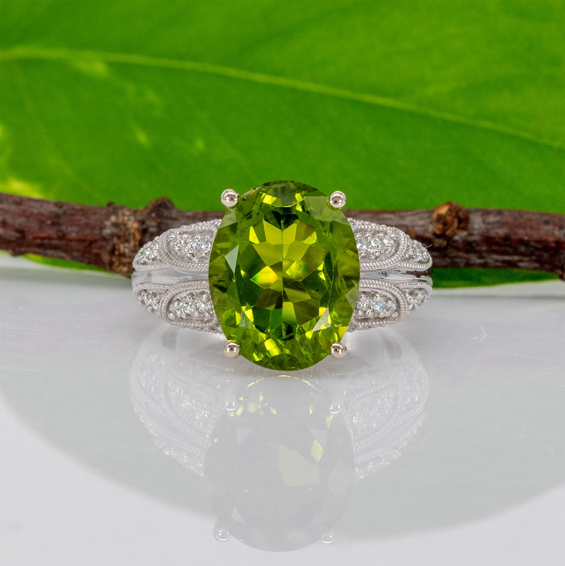 14K white gold peridot oval ring with diamond halo