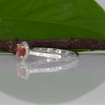 14K white gold padparadscha sapphire oval ring with diamond halo