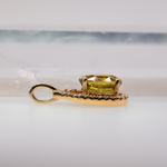 Sphene oval pendant with diamond accents in 14k yellow gold