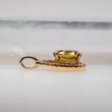 Sphene oval pendant with diamond accents in 14k yellow gold