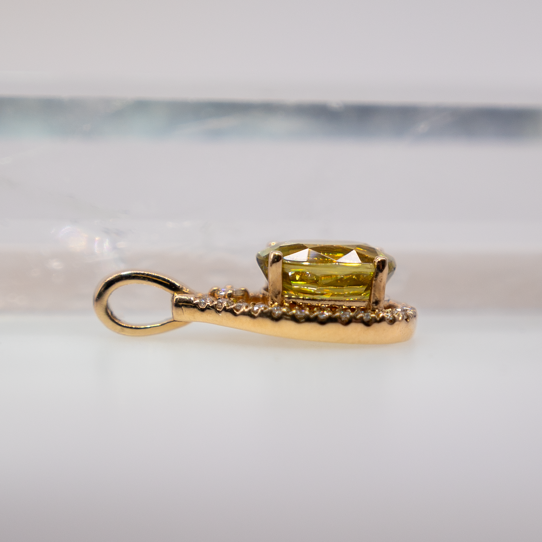 Sphene oval pendant with diamond accents in 14k yellow gold
