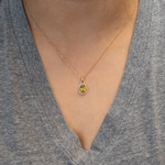 Sphene oval pendant with diamond accents in 14k yellow gold