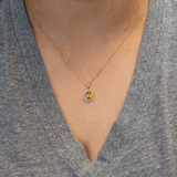 Sphene oval pendant with diamond accents in 14k yellow gold