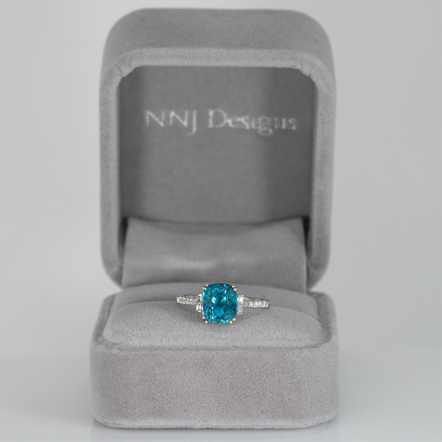 14K white gold Cambodian blue zircon cushion ring with diamond accents