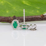 14K white gold emerald oval stud earrings with diamond halo