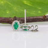 14K white gold emerald oval stud earrings with diamond halo