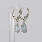 14K white gold aquamarine emerald-cut stud earrings with diamond halo