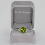 14K white gold peridot oval ring with diamond halo
