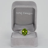 14K white gold peridot oval ring with diamond halo