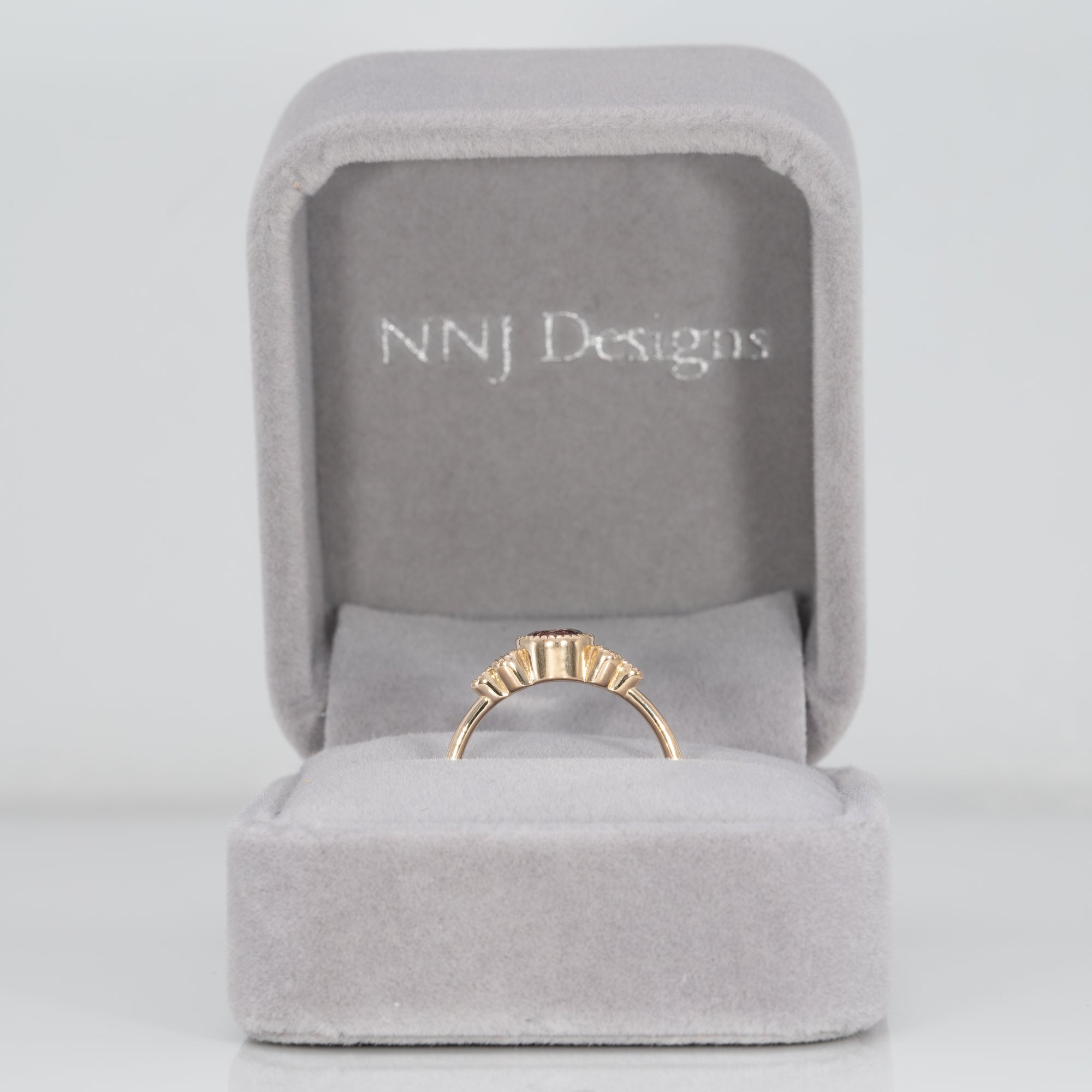 14K yellow gold bezel-set purple spinel ring with diamond accents