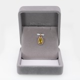 Sphene oval pendant with diamond accents in 14k yellow gold