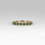 14K yellow gold band with round Zambian emerald accents