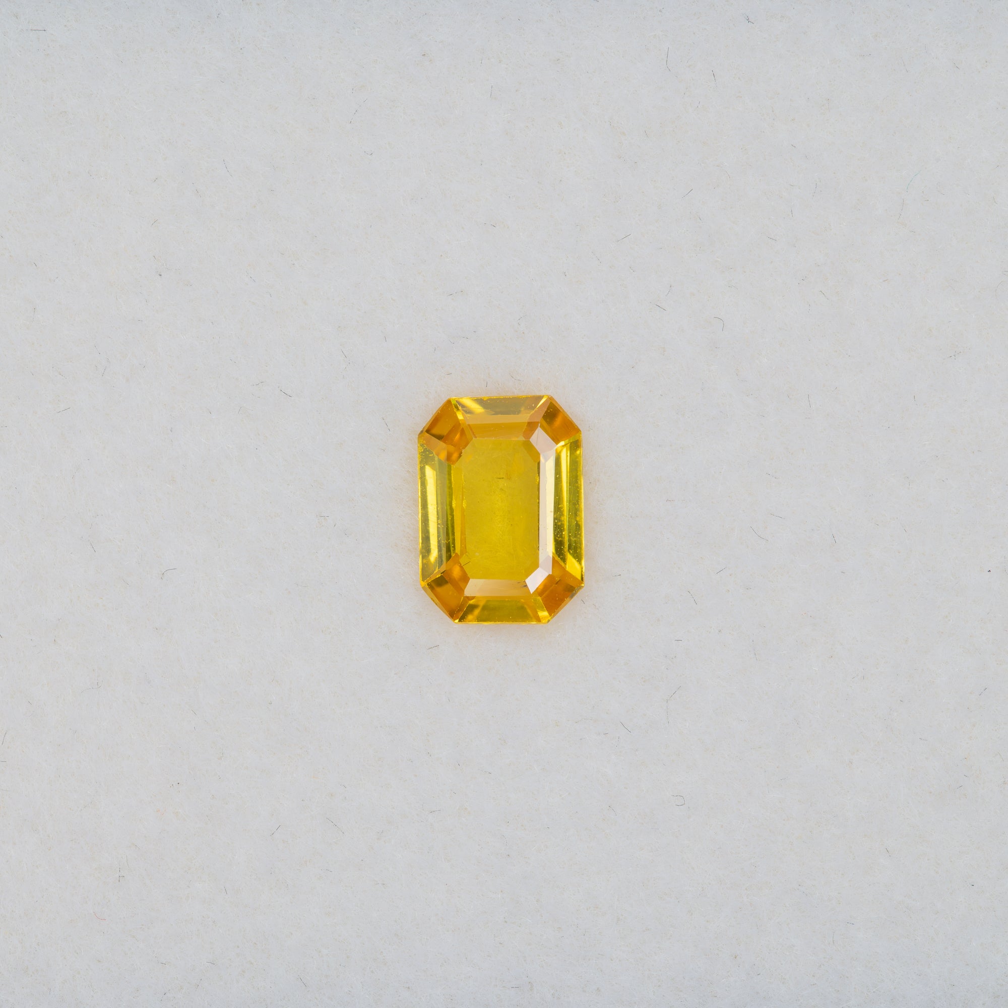 0.88 carat natural yellow sapphire, emerald cut 7x5mm loose yellow gemstone