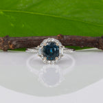 14K white gold teal sapphire oval ring with diamond halo