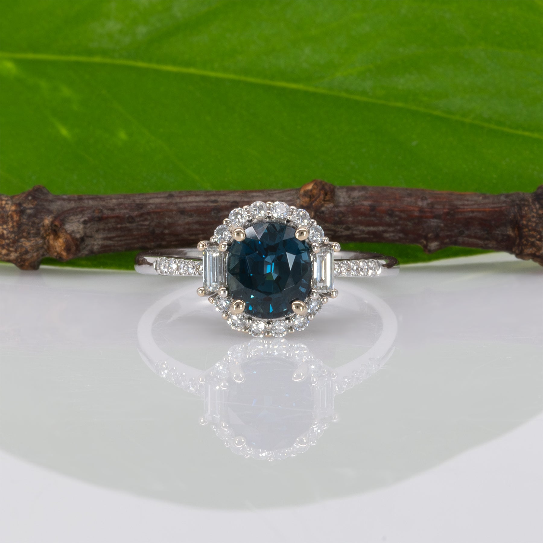 14K white gold teal sapphire oval ring with diamond halo