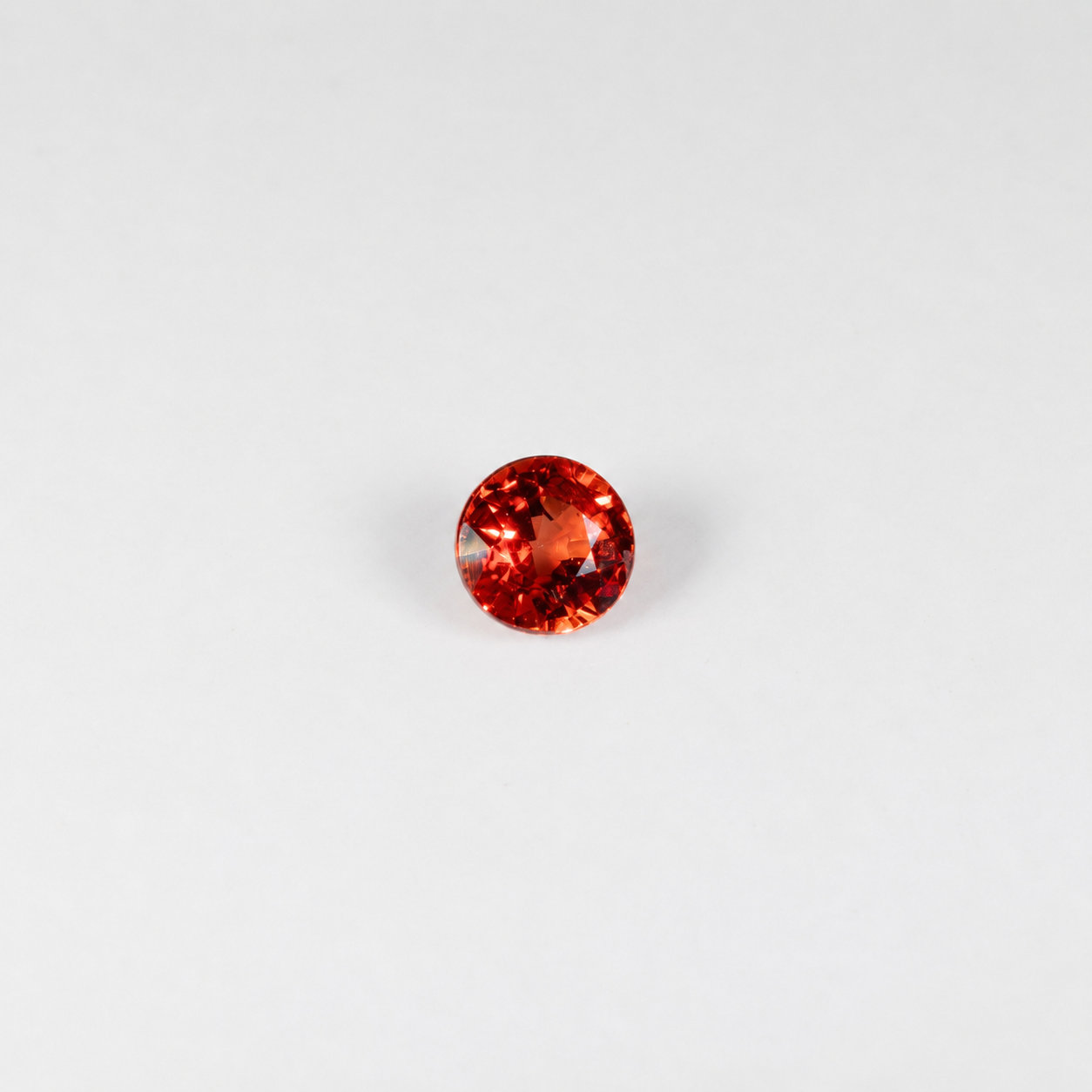 0.69 carat natural orange sapphire, round 5mm Ceylon loose gemstone