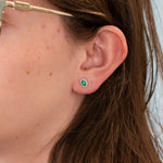 14K white gold emerald oval stud earrings with diamond halo