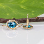 14K yellow gold London blue topaz oval stud earrings with diamond halo