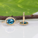 14K yellow gold London blue topaz oval stud earrings with diamond halo