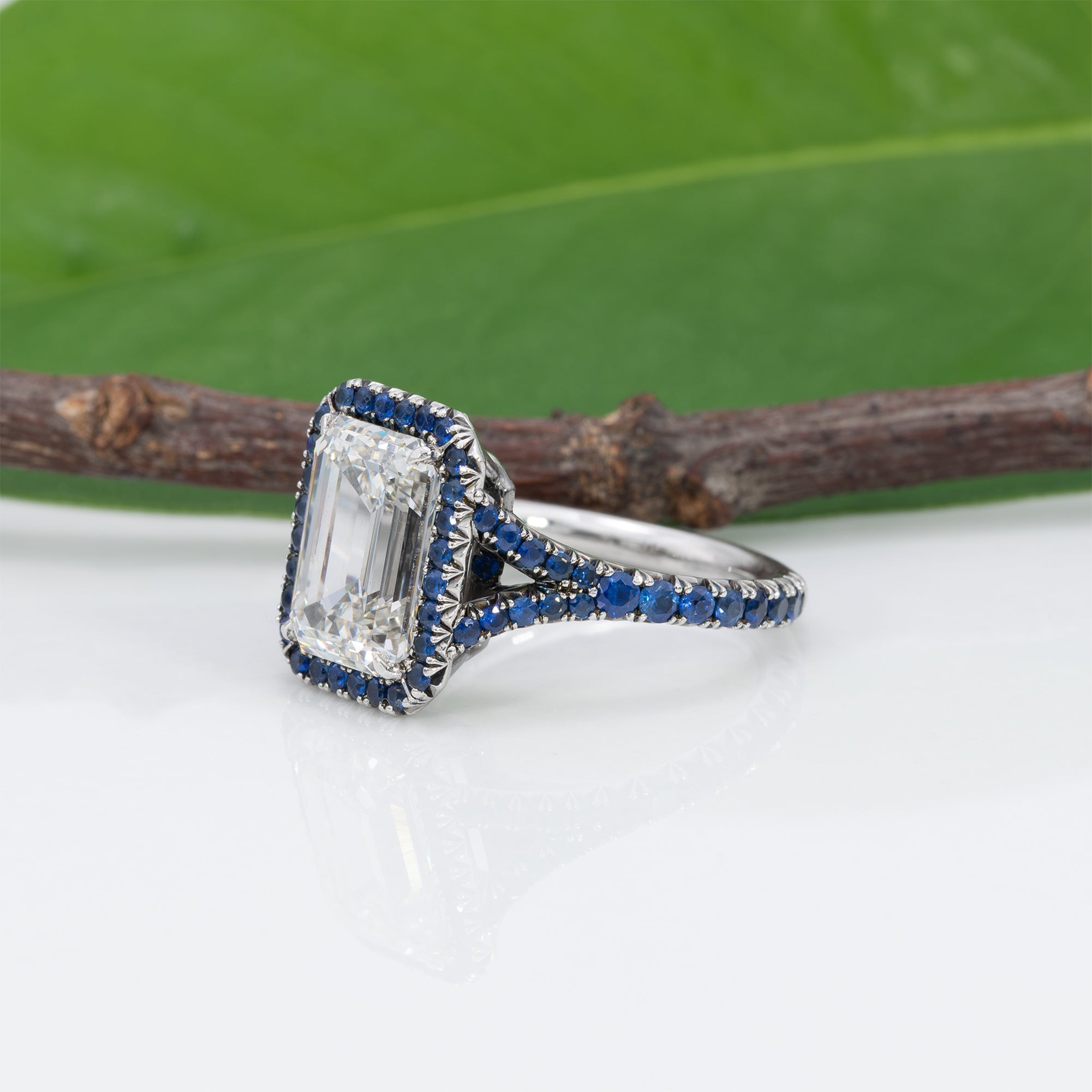 platinum lab grown diamond ring with blue sapphire accents