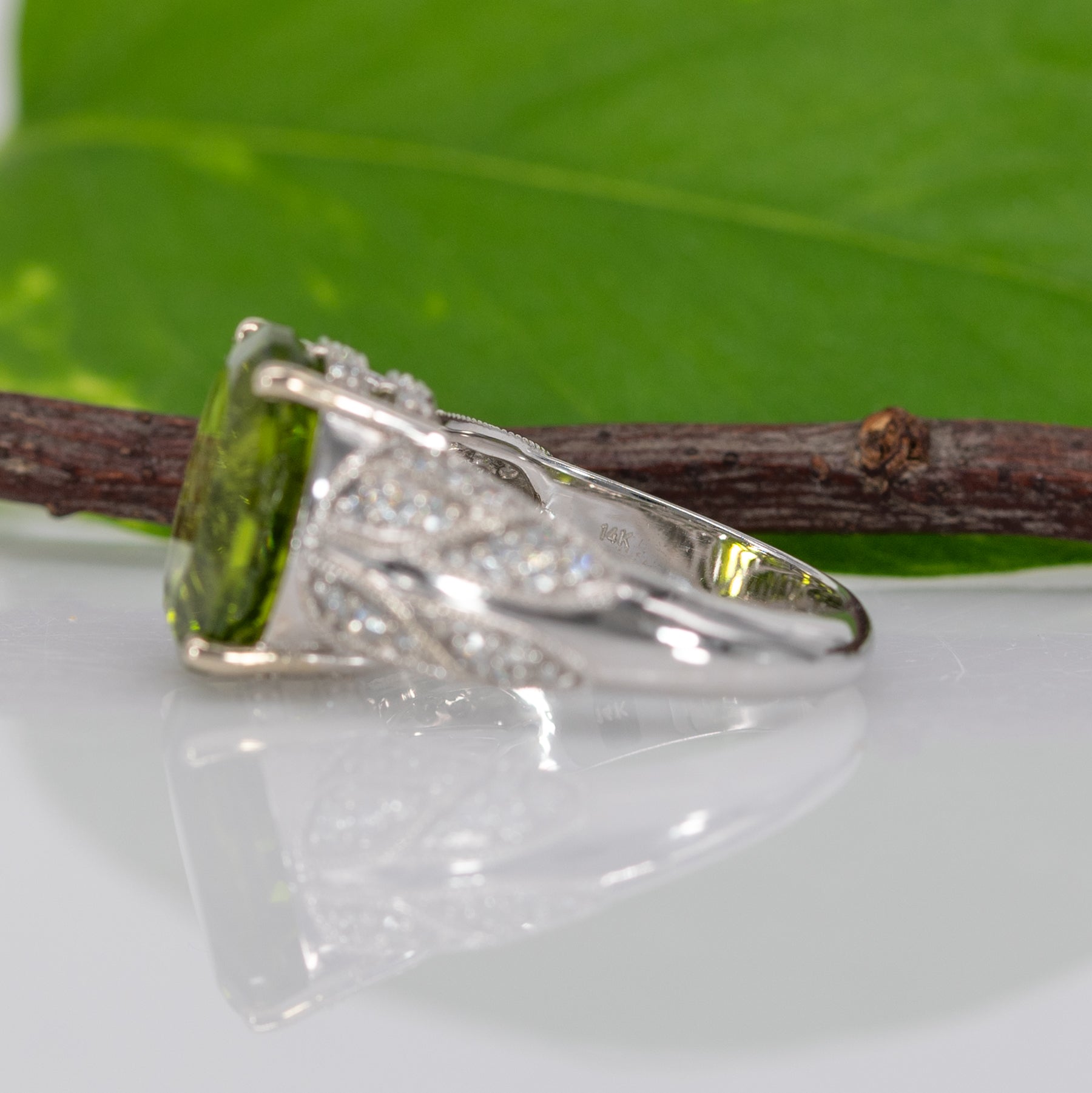 14K white gold peridot oval ring with diamond halo