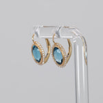 14K yellow gold London blue topaz oval stud earrings with diamond halo