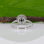 14K white gold teal sapphire oval ring with diamond halo