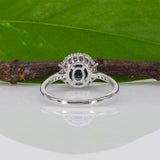14K white gold teal sapphire oval ring with diamond halo