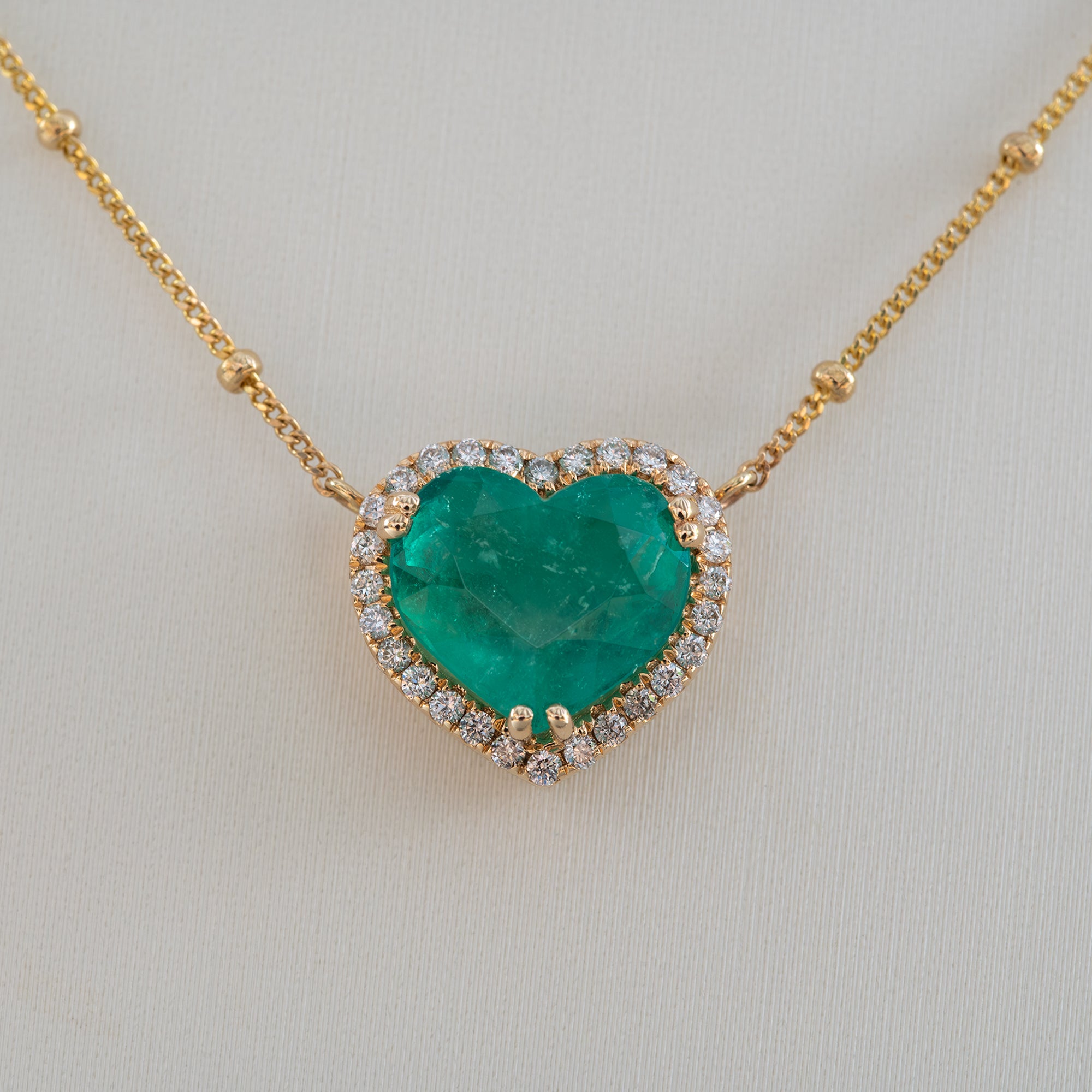 14K yellow gold colombian emerald pendant with diamond accents
