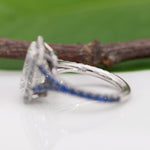 platinum lab grown diamond ring with blue sapphire accents