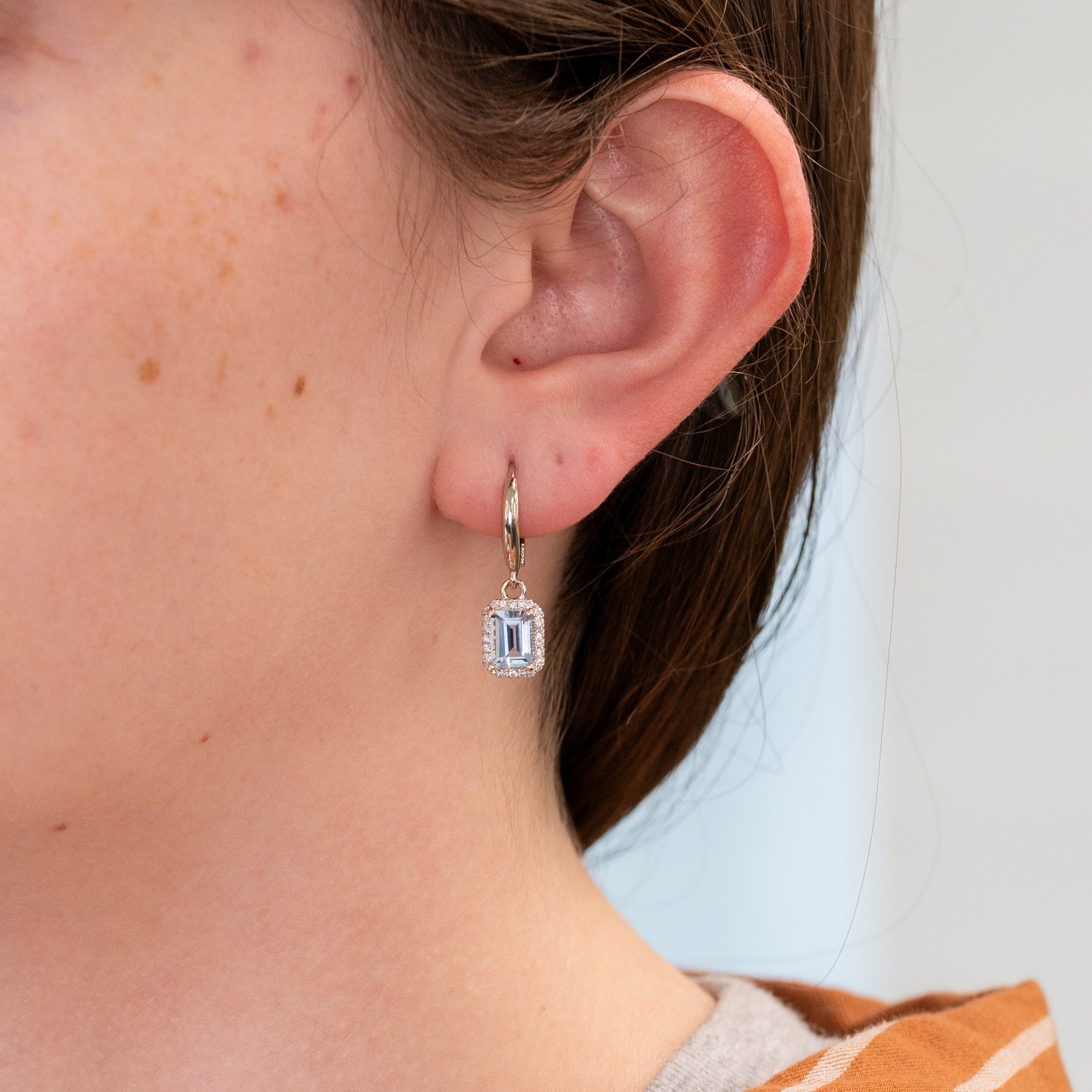 14K white gold aquamarine emerald-cut stud earrings with diamond halo