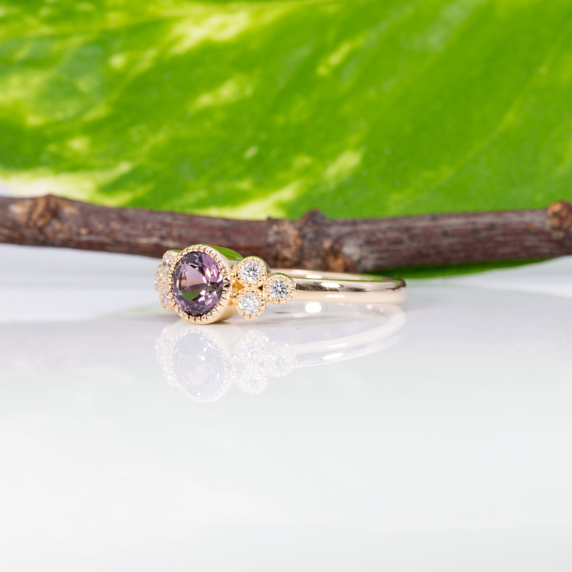 14K yellow gold bezel-set purple spinel ring with diamond accents