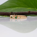14K yellow gold Zambian emerald band ring with diamond accents