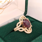 Celtic Inspired Woven Diamond Halo Ring Design with a Heated Ruby in Solid 14k Yellow Gold