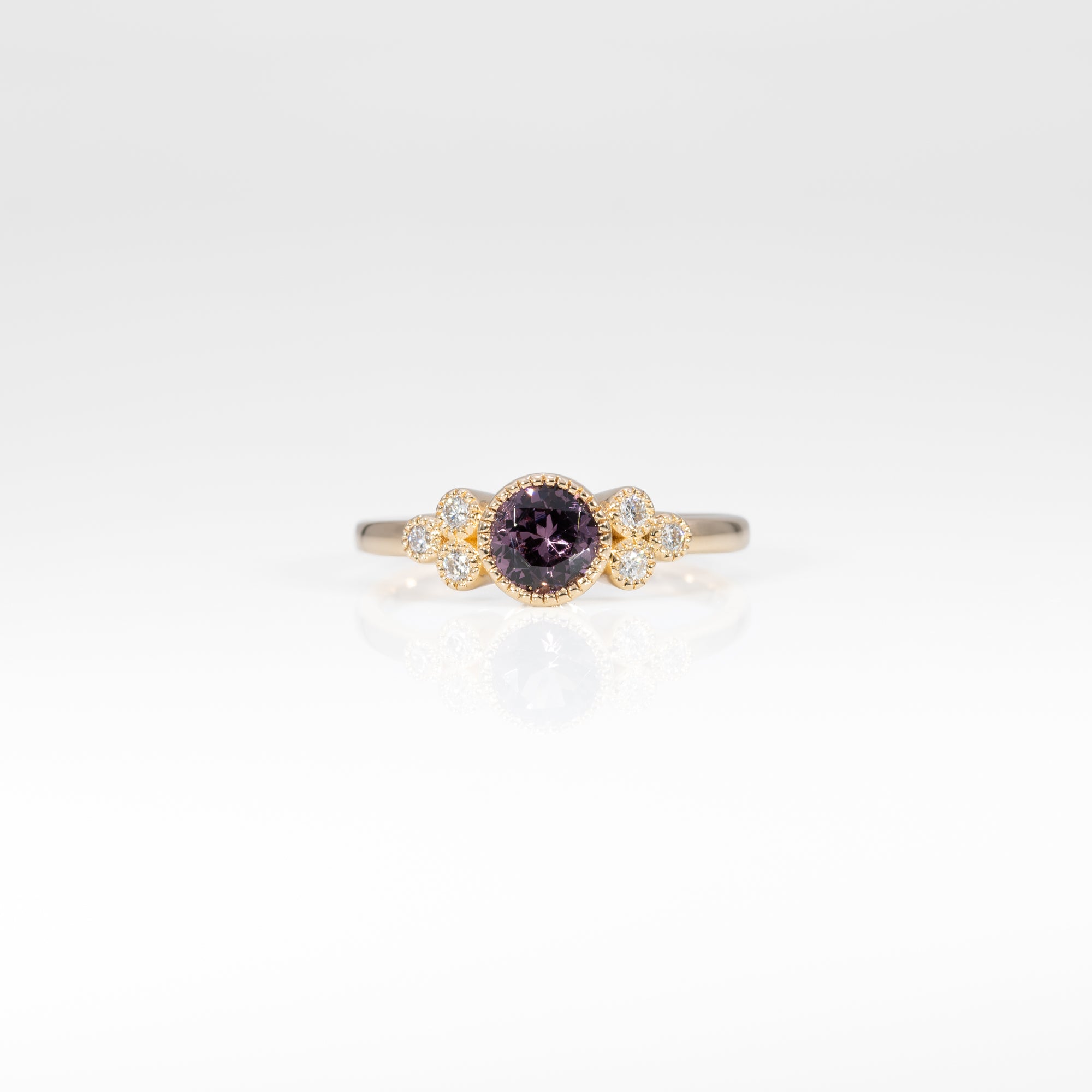 14K yellow gold bezel-set purple spinel ring with diamond accents