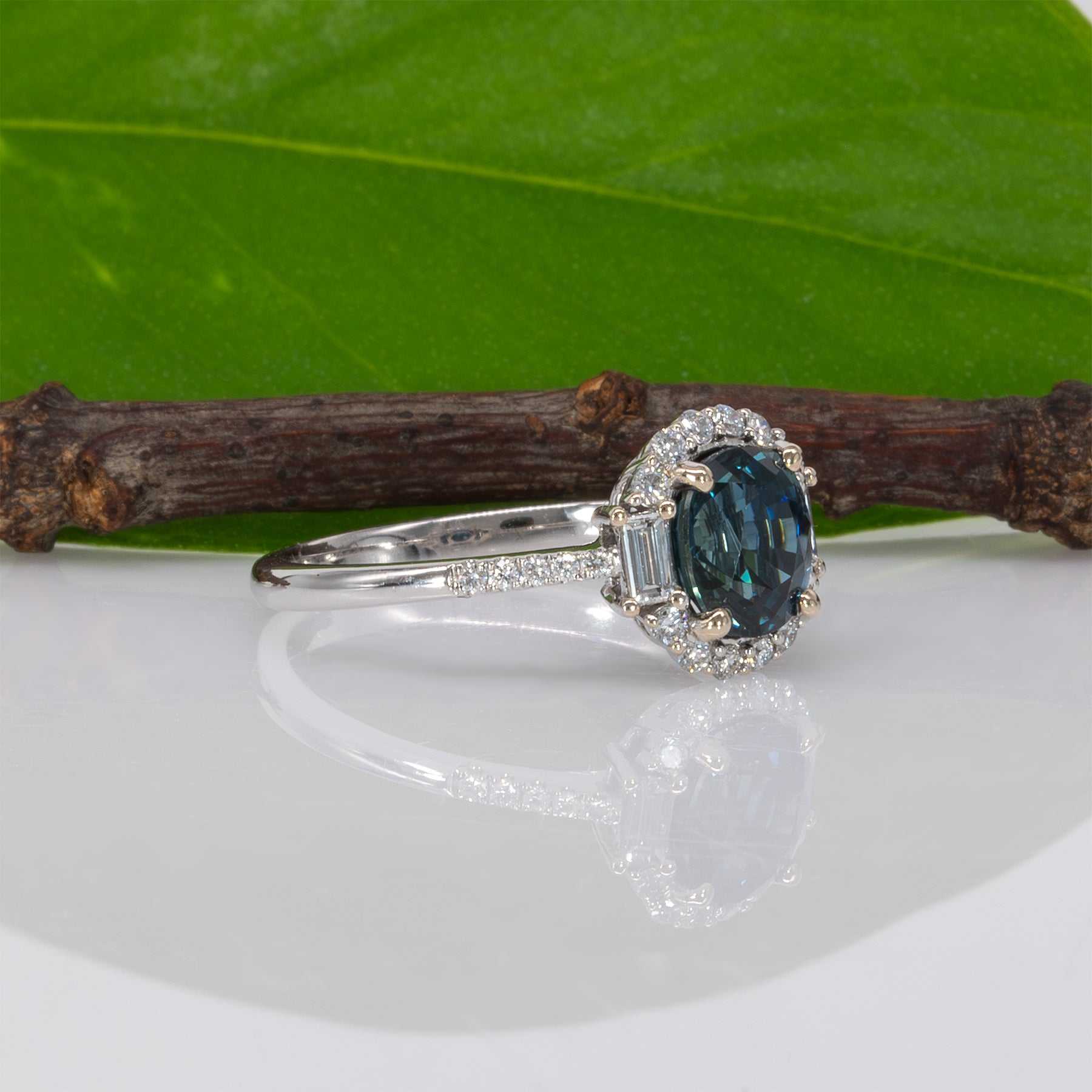 14K white gold teal sapphire oval ring with diamond halo